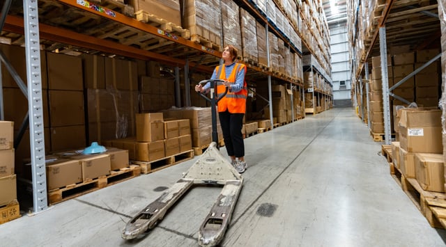A fulfilmentcrowd employee with a forklift in the warehouse